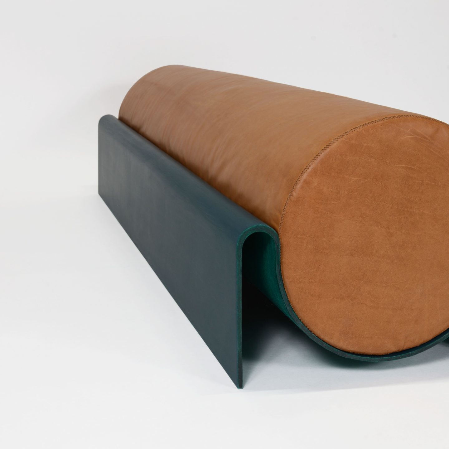 Bench in fiberglass with a cylindrical leather cushion designed by Asa Pingree