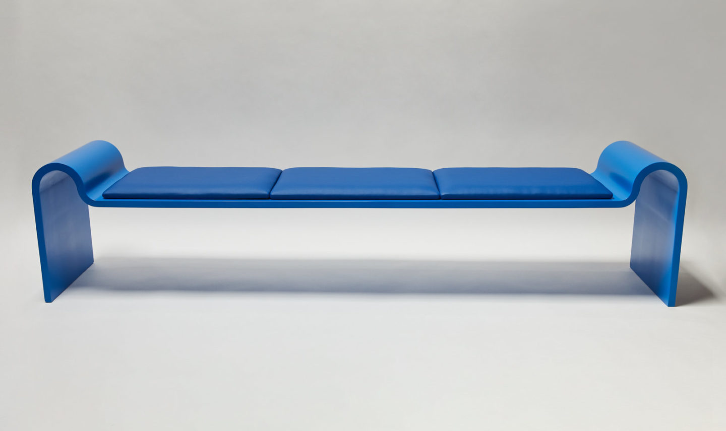Bench in fiberglass with upholstered cushions designed by Asa Pingree